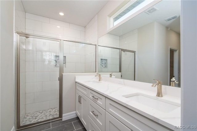 bathroom with vanity and a shower with door