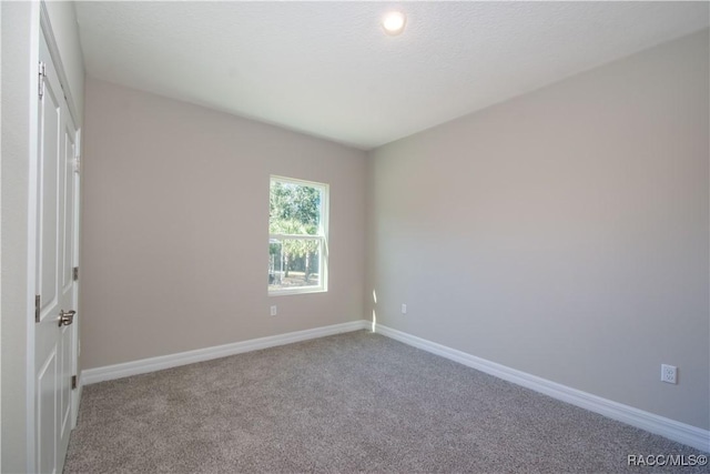 unfurnished room featuring carpet flooring