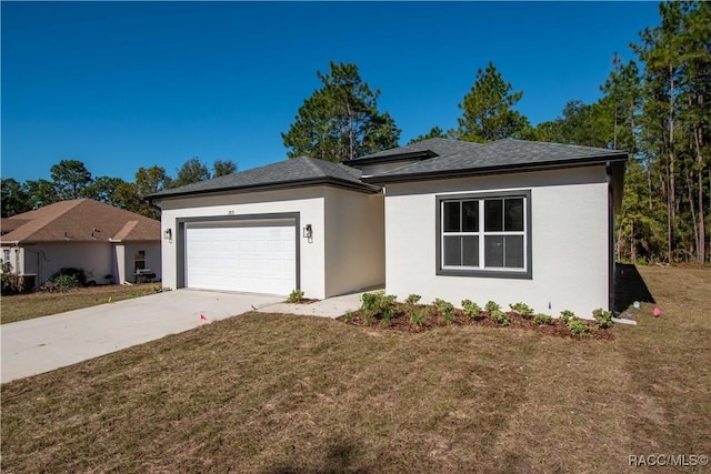 view of front of home featuring a front yard and a garage