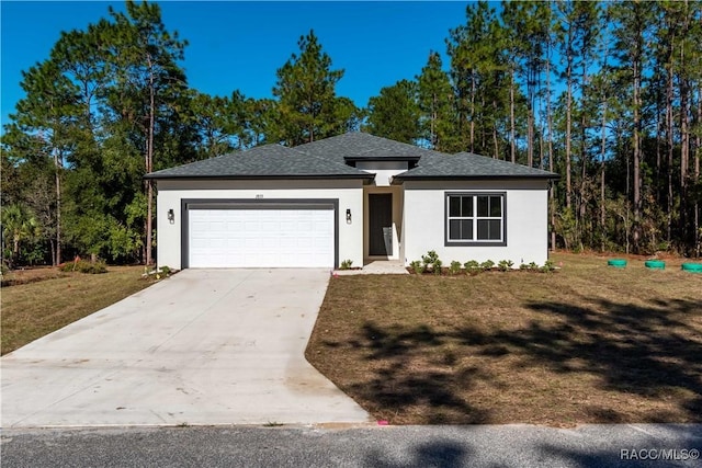 view of front of home with a garage and a front lawn