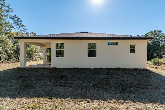 view of side of property with a patio area