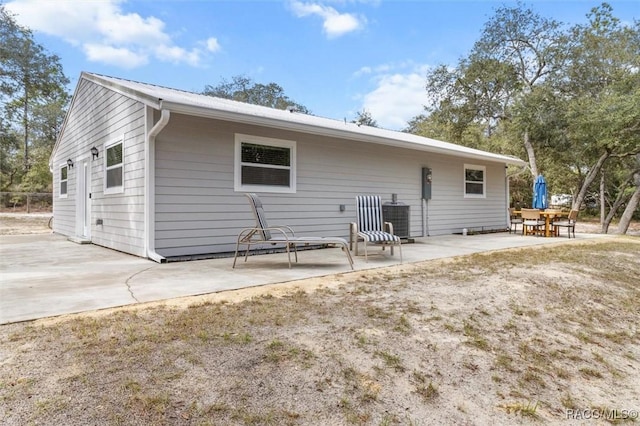 back of property with a patio area and central air condition unit