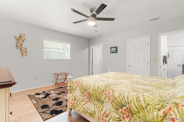 bedroom featuring ceiling fan, connected bathroom, and light hardwood / wood-style flooring