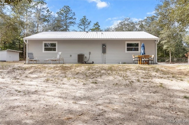 rear view of property featuring central AC unit