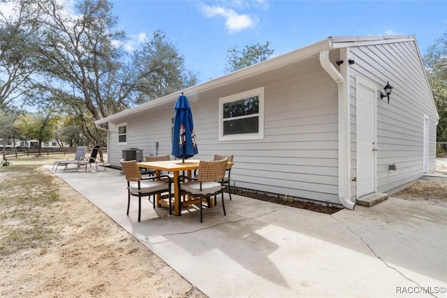 rear view of property featuring central AC unit and a patio