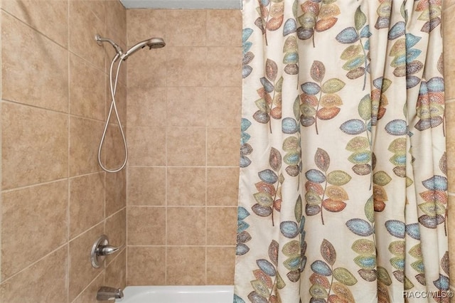 bathroom featuring shower / bathtub combination with curtain