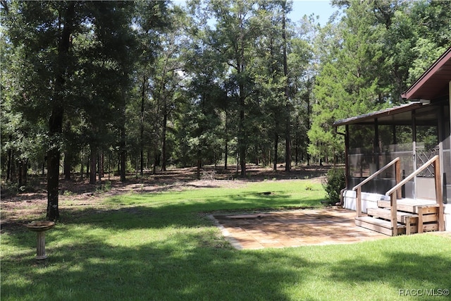 view of yard with a patio area and a sunroom