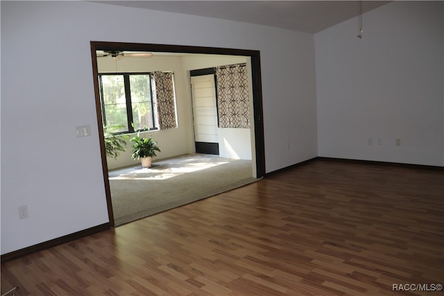 spare room featuring ceiling fan and dark hardwood / wood-style flooring