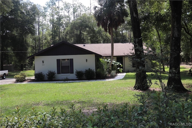 ranch-style home featuring a front yard