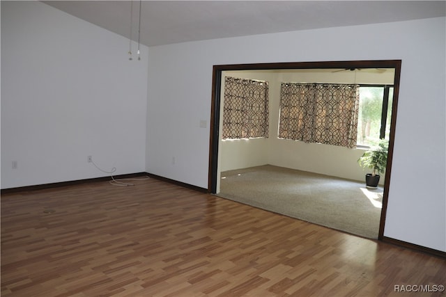 unfurnished room featuring hardwood / wood-style flooring