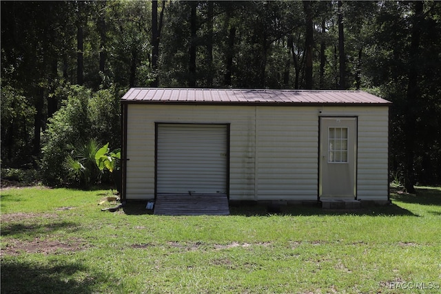 view of outbuilding featuring a lawn