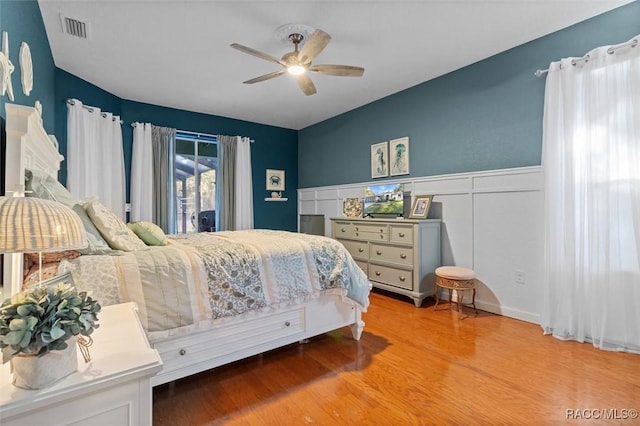 bedroom featuring access to outside, ceiling fan, and hardwood / wood-style floors