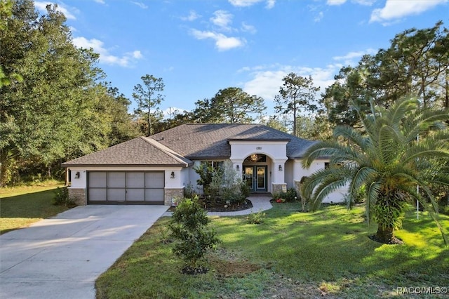 view of front of property featuring a garage and a front lawn