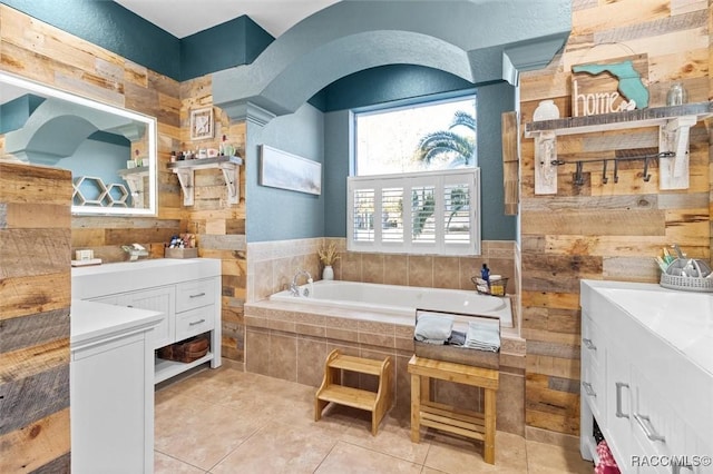 bathroom with vanity, tile patterned floors, and tiled tub