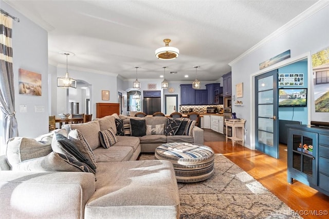 living room with dark hardwood / wood-style floors and ornamental molding