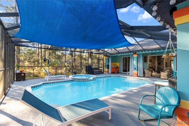 view of swimming pool featuring an in ground hot tub and a patio area