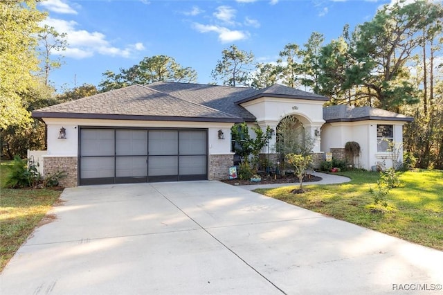 view of front of home with a garage and a front lawn