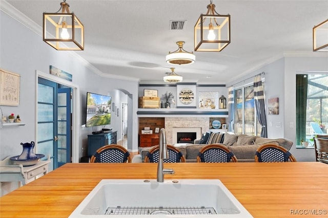 dining space featuring ornamental molding and sink