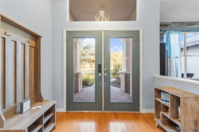 doorway with light hardwood / wood-style floors and french doors