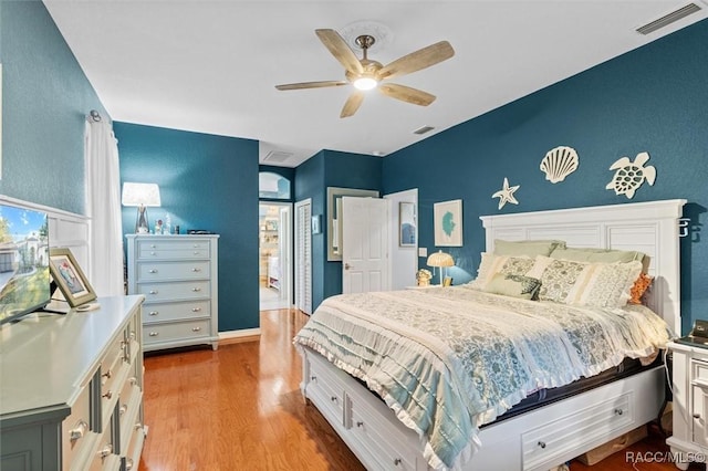 bedroom with hardwood / wood-style floors and ceiling fan