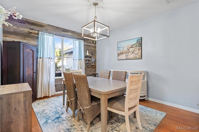 dining space featuring a notable chandelier and light wood-type flooring