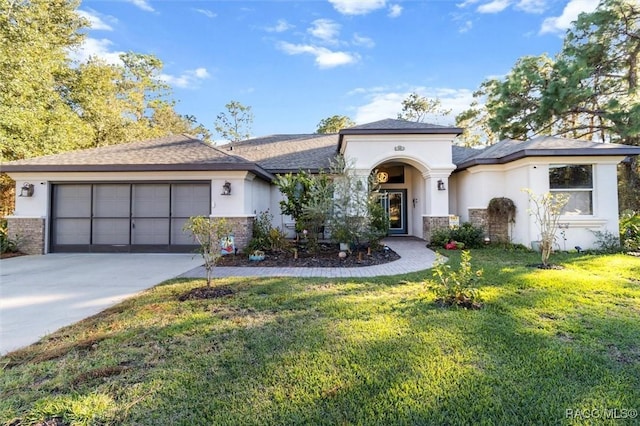 view of front of property featuring a garage and a front lawn