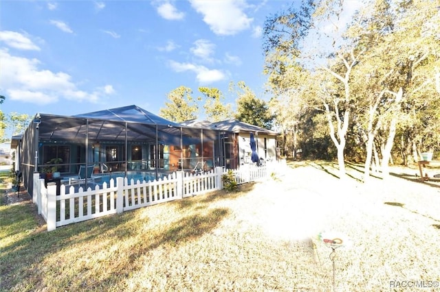 rear view of property with glass enclosure