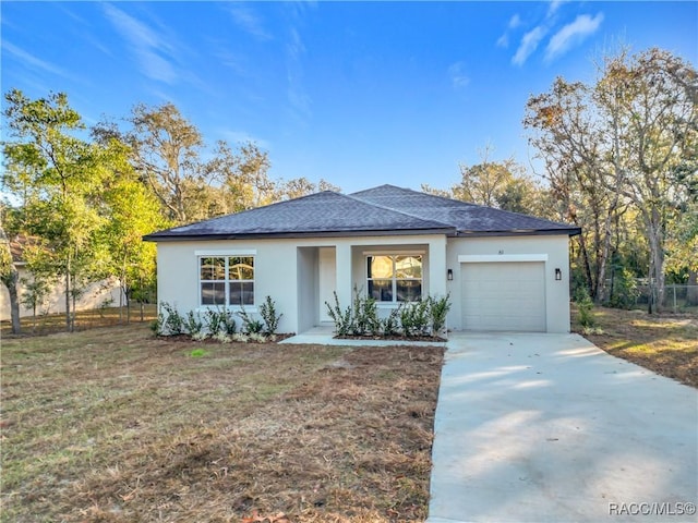 view of front facade featuring a garage and a front lawn