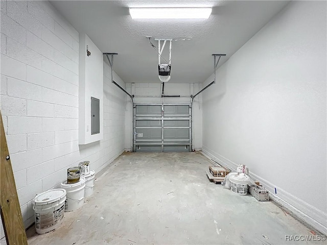 garage with a garage door opener and electric panel