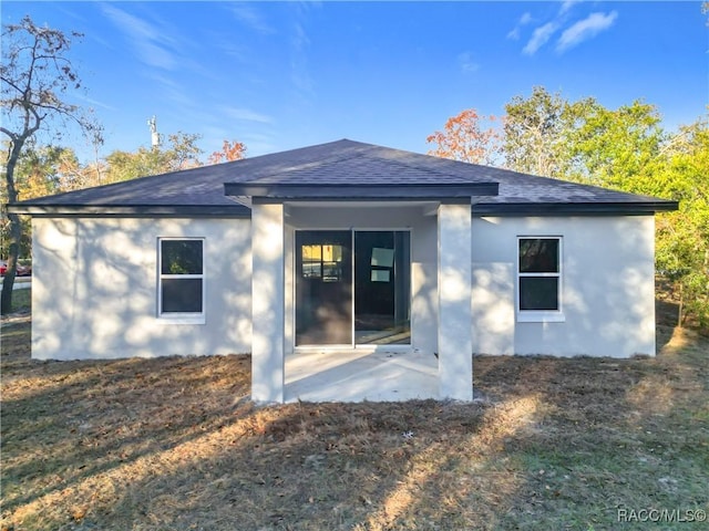 back of house with a patio