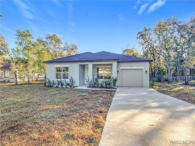 view of front of home with a garage and a front lawn