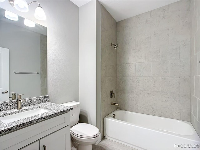 full bathroom with tiled shower / bath, vanity, and toilet