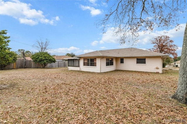 rear view of house featuring a sunroom