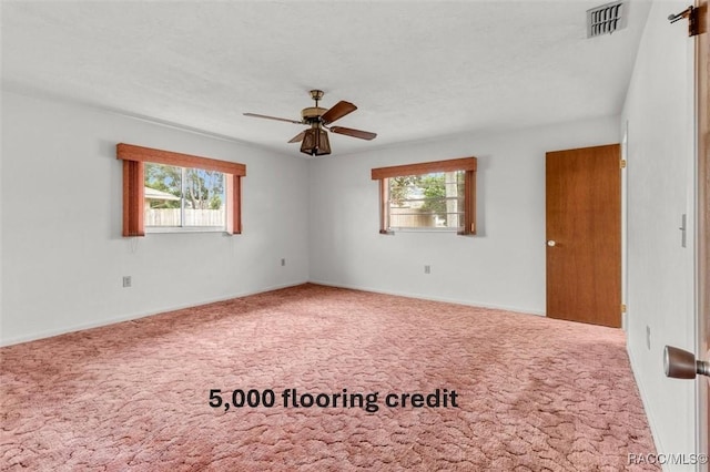 unfurnished room with ceiling fan and carpet flooring