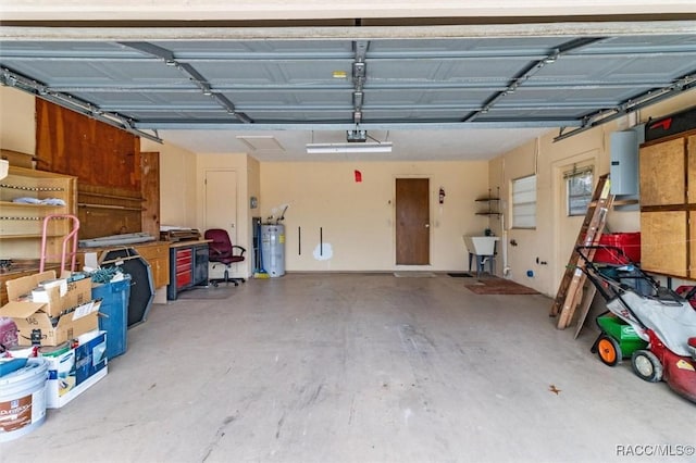 garage featuring sink, a garage door opener, and water heater