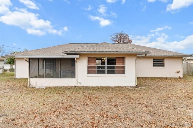 back of property with a sunroom