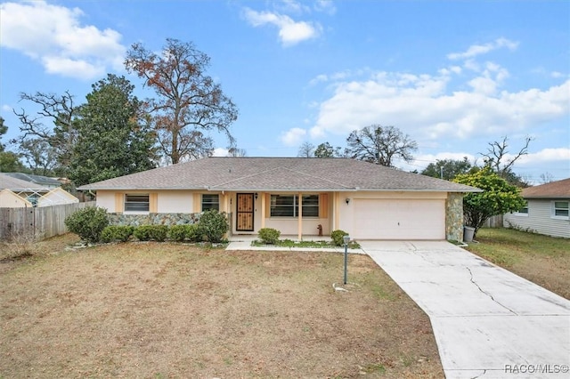 ranch-style home featuring a garage and a front lawn