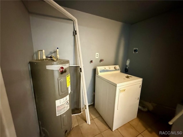 laundry area featuring washer / dryer, electric water heater, and light tile patterned flooring