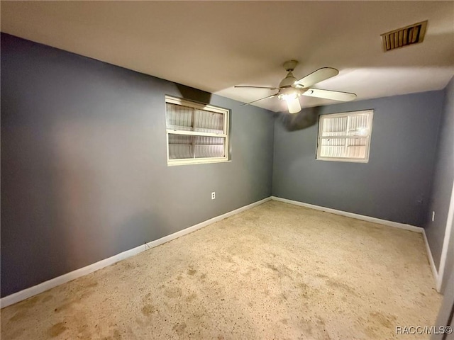 unfurnished room with ceiling fan