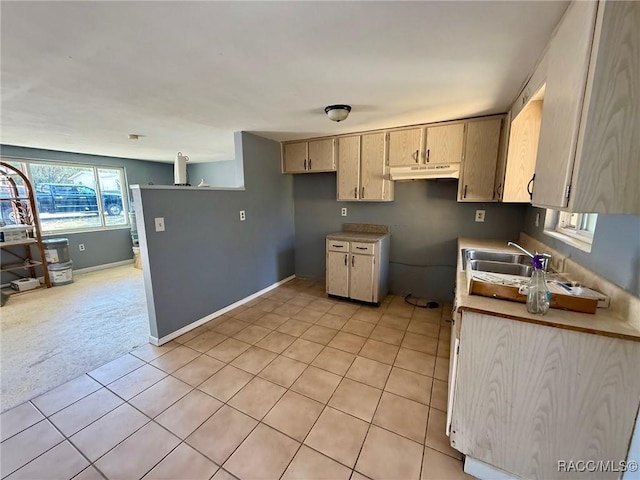 kitchen featuring light tile patterned flooring, sink, and light brown cabinets