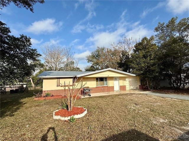 view of front of house with a garage, covered porch, and a front lawn