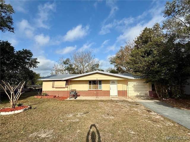 ranch-style house with a garage, a front yard, and a porch