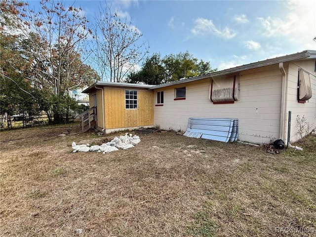 rear view of house with a lawn