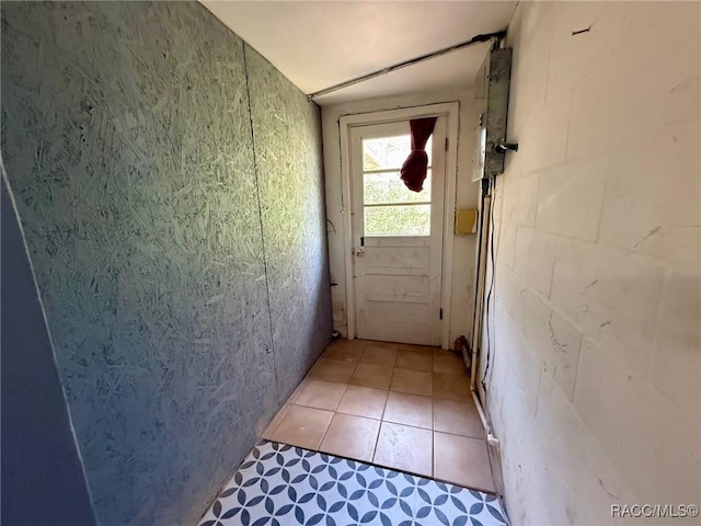 doorway with light tile patterned floors