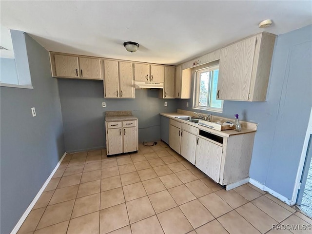 kitchen featuring sink, light brown cabinets, and light tile patterned floors