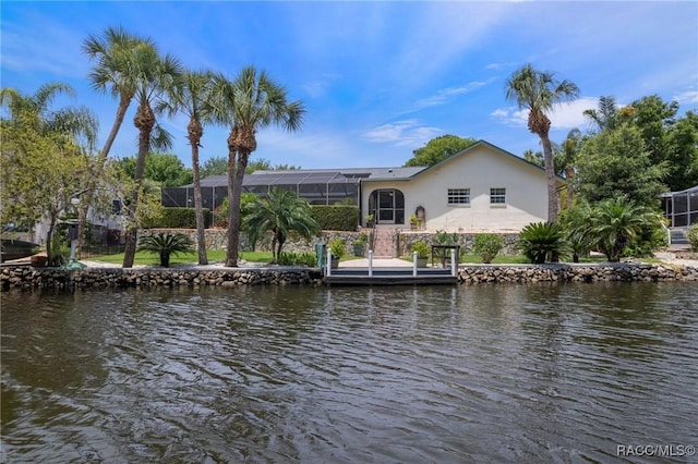 dock area with a water view and a lanai