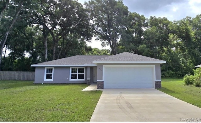 single story home featuring concrete driveway, stone siding, an attached garage, fence, and a front lawn