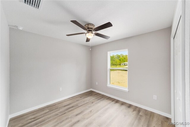 laundry room featuring a textured ceiling, hookup for an electric dryer, laundry area, wood finished floors, and baseboards