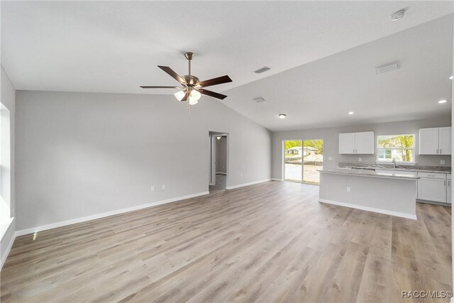 dining space featuring lofted ceiling, recessed lighting, a ceiling fan, visible vents, and light wood-style floors