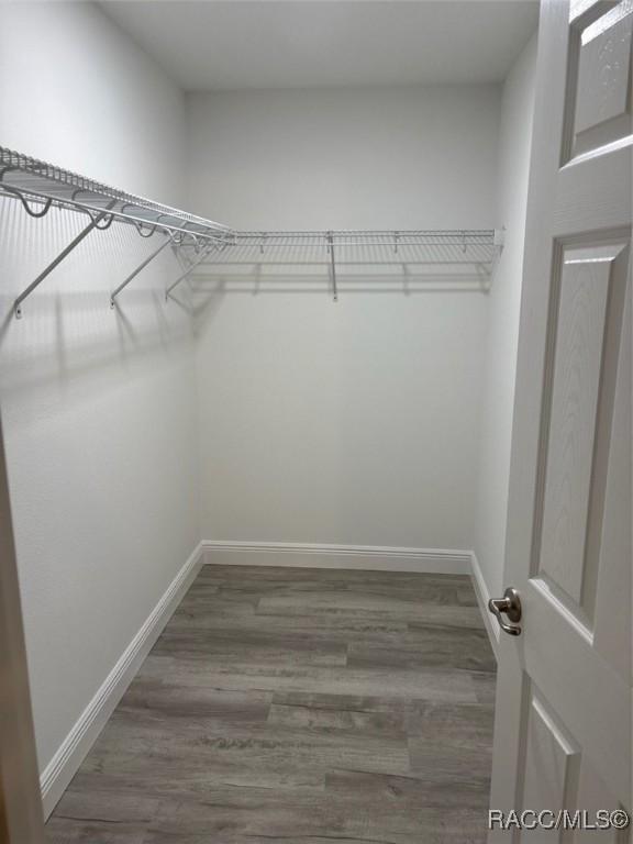 full bathroom featuring toilet, marble finish floor, vanity, and a stall shower